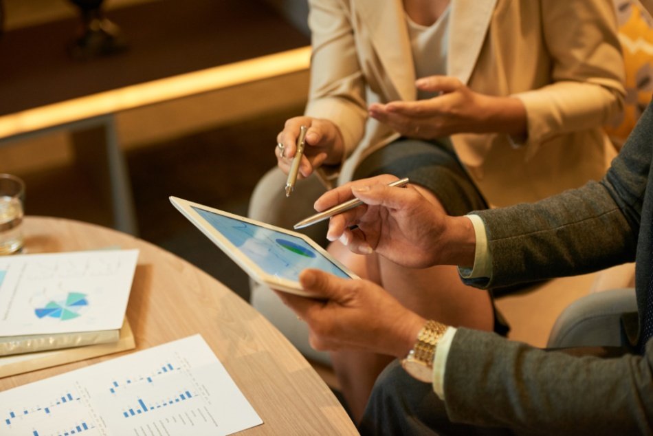 a close-up of a man and woman using a tablet
