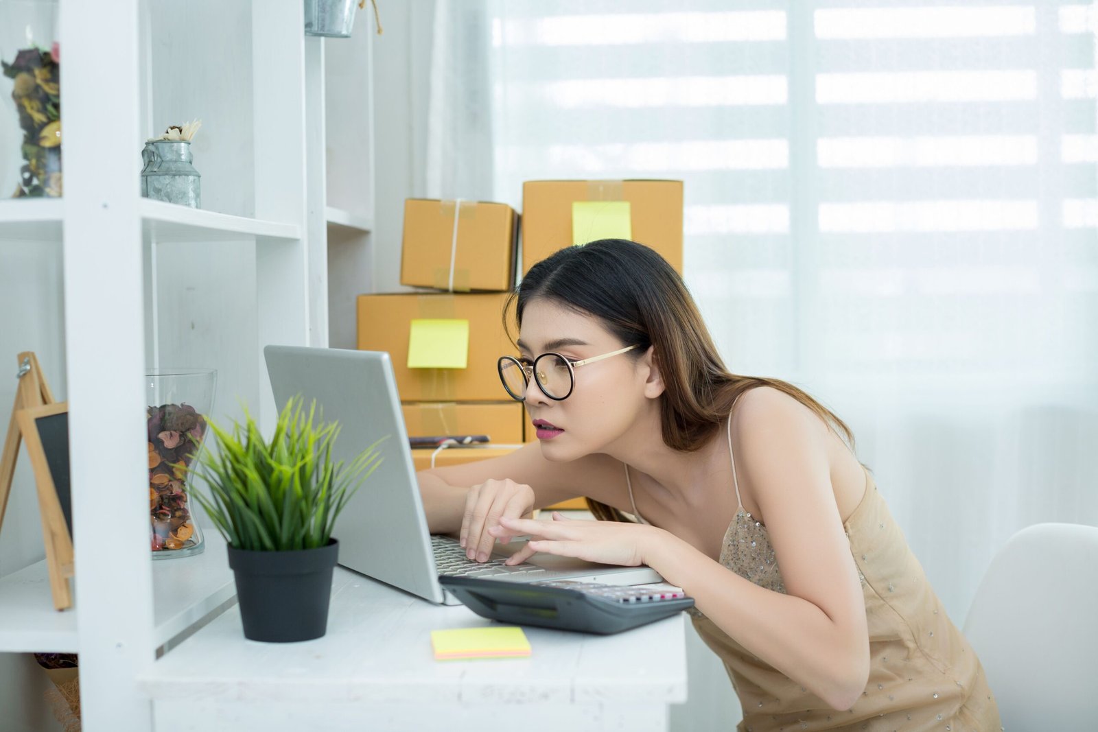 a woman sitting at a desk with a laptop